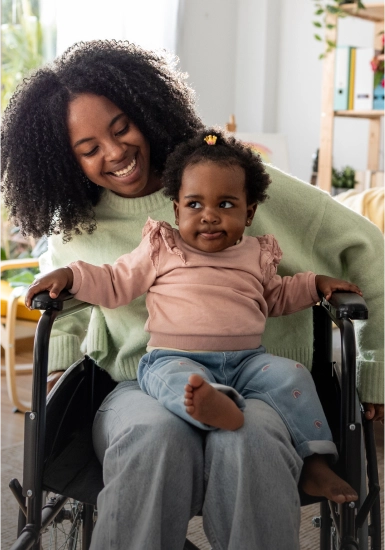 Mother in wheelchair with daughter on her lap