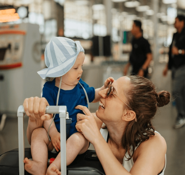 woman with her child in an airport heading on their dream vacation