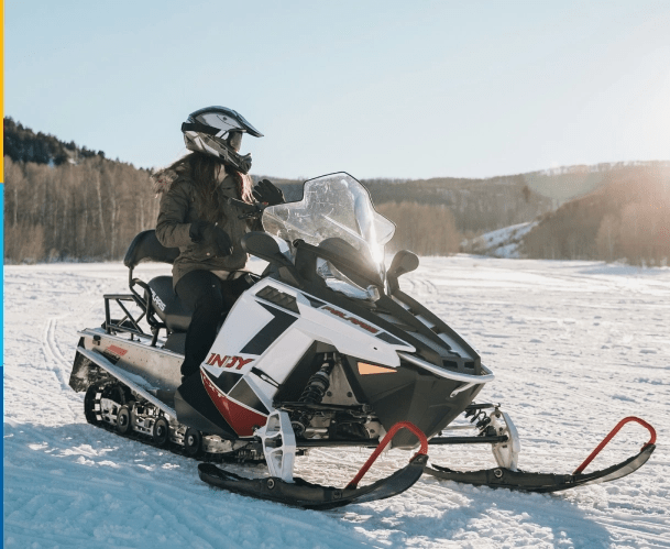 Young woman covered by snowmobile insurance